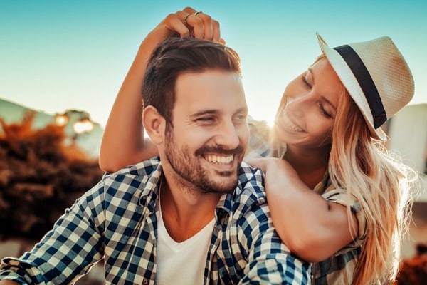 Joyful couple dancing outdoors at sunset