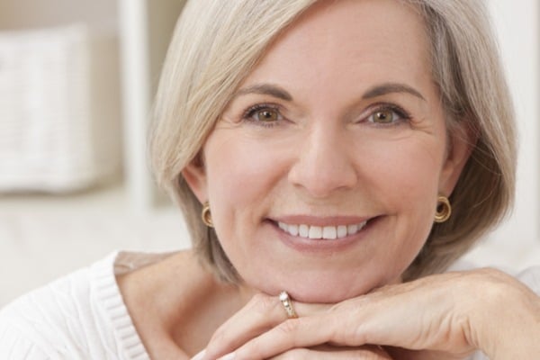 Smiling elderly woman with white hair and ring